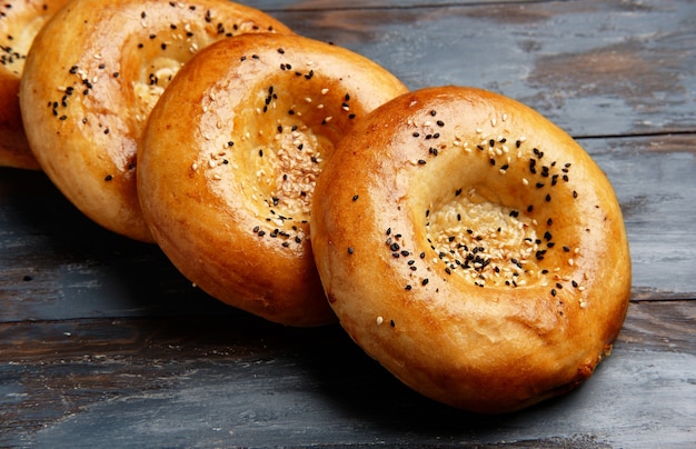 National uzbek bread on wood background. Traditional food. Top view