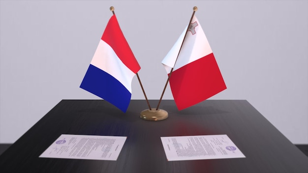 Nationale vlaggen van Malta en Frankrijk op tafel in diplomatieke vergaderruimte Politieke overeenkomst