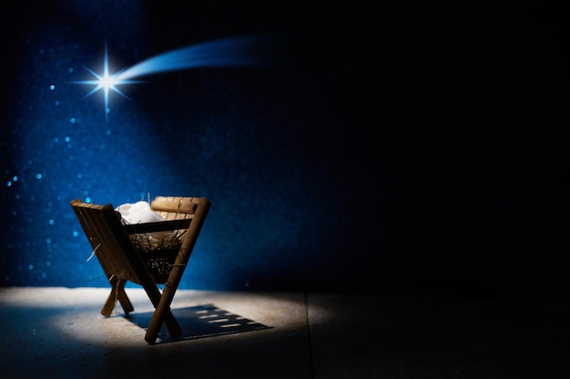 Nativity of Jesus empty manger at night with bright lights