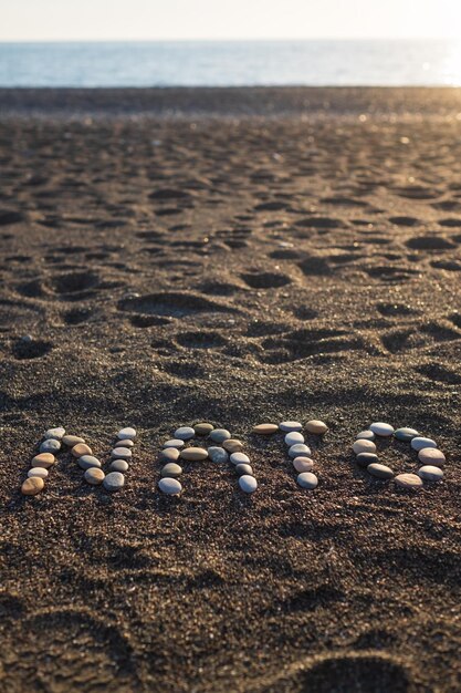 NATO word made with stones on sande beach