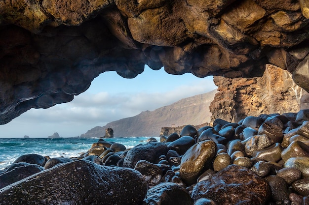 Natural arch of stones next to the La Maceta rock pool on the island of El Hierro en la Frontera Canary Islands