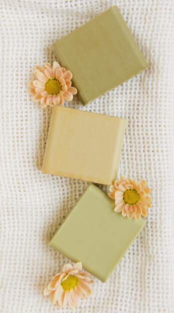 Natural aroma homemade soap with flowers on a white cotton
towel eco handmade natural care of body concept