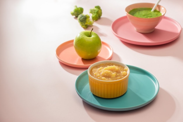 Natural baby food concept. Different types of vegetable puree on the light background