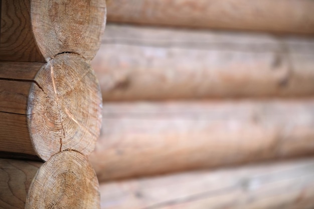 Natural background pattern of log wall Construction of houses made of wood rounded timber