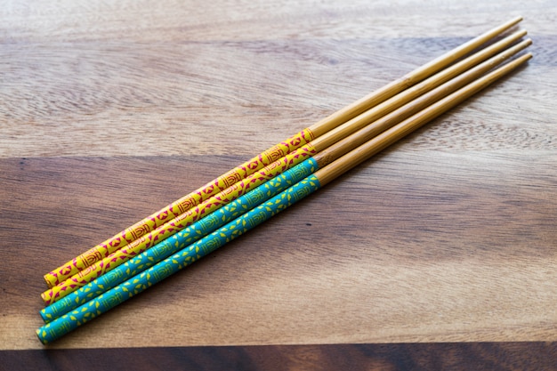 NATURAL BAMBOO CHOPSTICKS on wooden table background