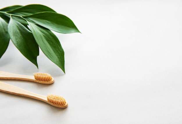 Natural bamboo toothbrushes on gray background