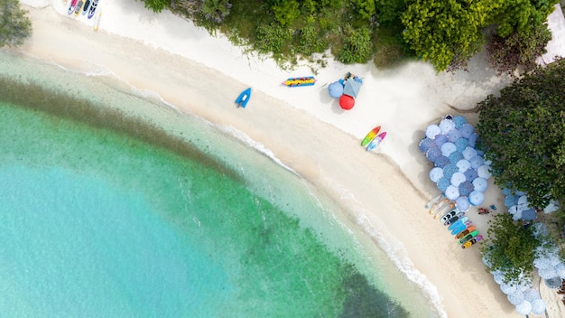 Natural Beach concept summer vacation Nature of tropical summer beach Umbrella board a boat and boat on the Sand Beach and Tourism Happy for playing on sand