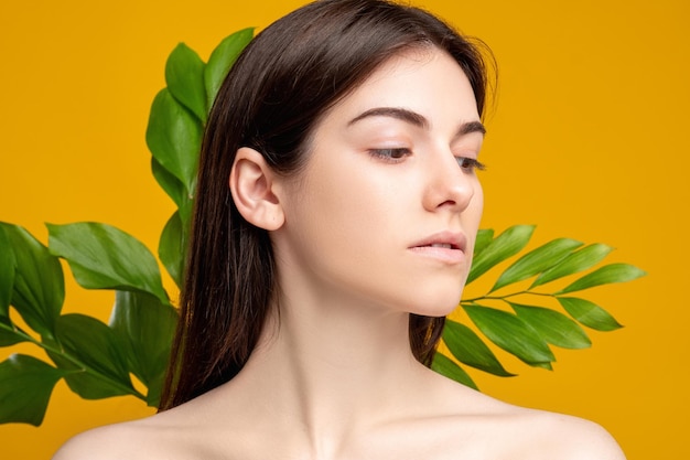 Natural beauty spa therapy portrait of woman with fresh smooth face bare shoulders skin with exotic