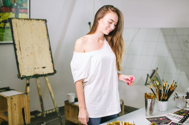 Natural beauty teacher painter in her studio preparing to an art class