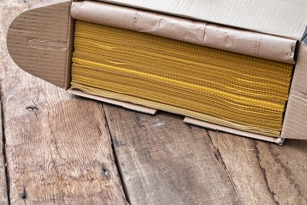 Natural beeswax package wrapped in craft paper on old wooden table