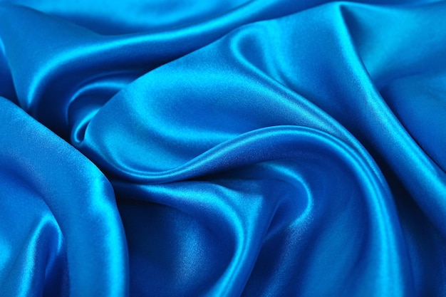 Натуральная синяя атласная ткань в качестве фоновой текстуры