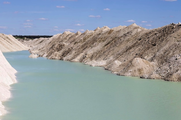 Natural blue water in chalk quarries against a blue sky