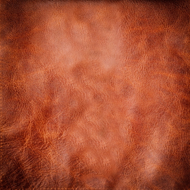 Natural brown leather background or texture with vignette