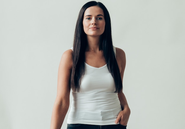 Natural brunette woman long hair casual makeup. Studio shot.