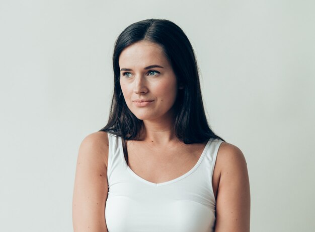 Natural brunette woman long hair casual makeup. Studio shot.