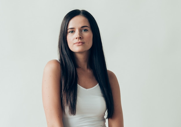 Natural brunette woman long hair casual makeup. Studio shot.