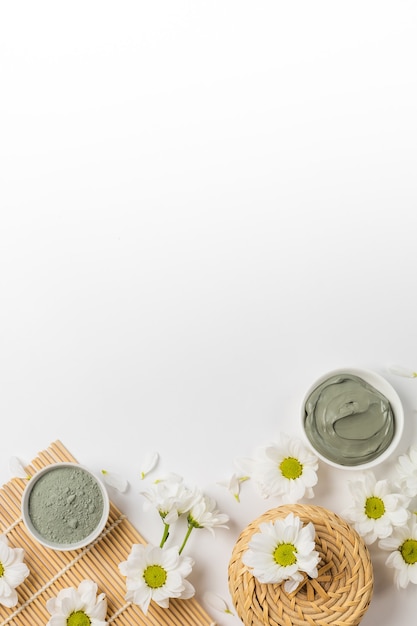 Natural clay mask dry and wet with flowers on a white background