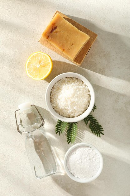 Natural cleaning products bottle and branch on beige background top view