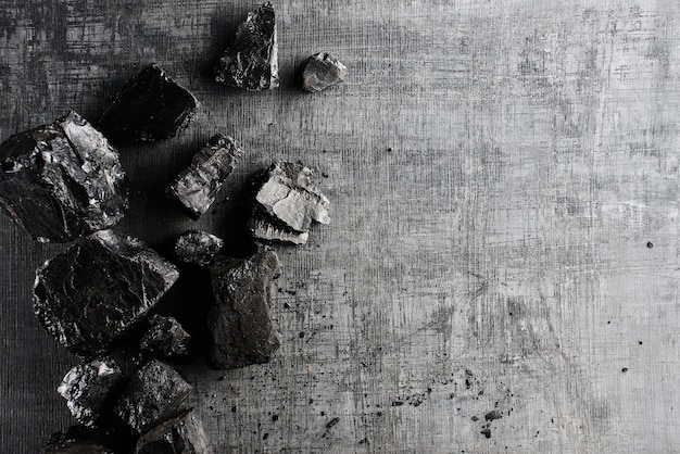 Natural coal on a black background isolated closeup. Extraction of natural mineral resources.