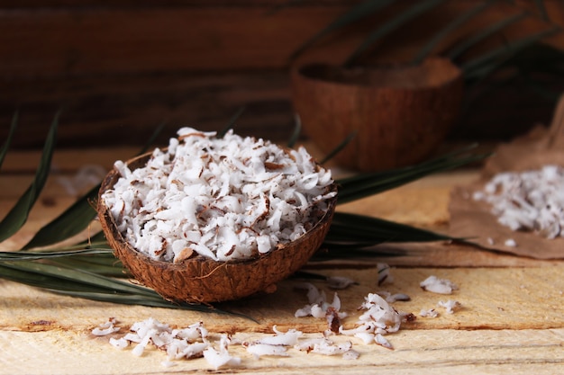 Natural coconut flakes on the table closeup