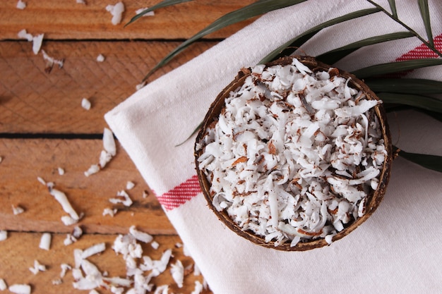 Natural coconut flakes on the table closeup