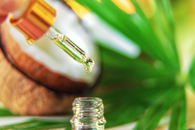 Photo natural coconut oil in a bottle. selective focus.