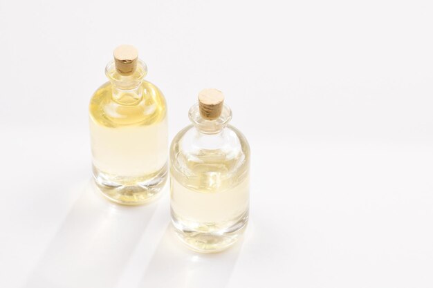 Natural coconut oil in bottles on white background