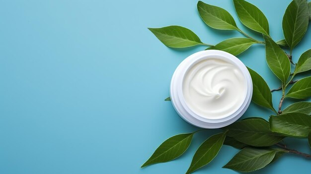 Photo natural cosmetic cream jar with green leaves on blue