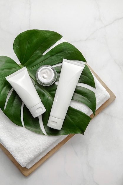 Natural cosmetic products set with leaf on marble