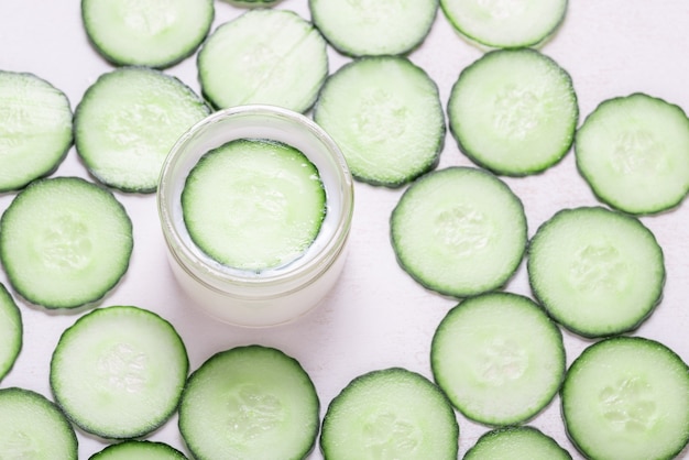 Natural cream with cucumber on white background