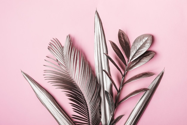 Natural Creative layout made of tropical leaves in silver metallic colors Minimal surrealism background