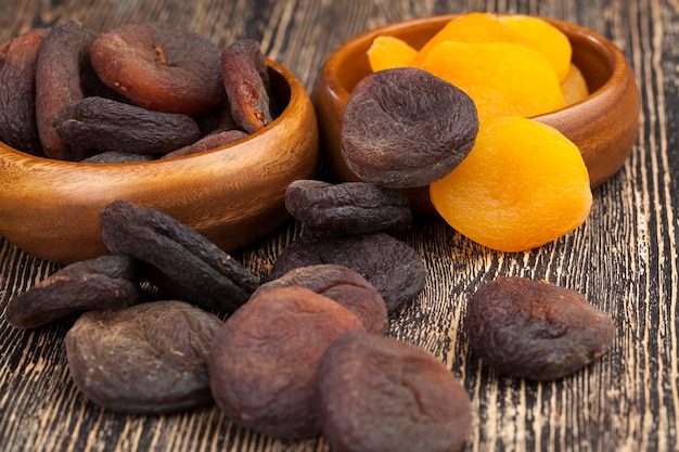 Natural dark-colored sweets made from apricot fruit, natural dried apricots in the sunlight