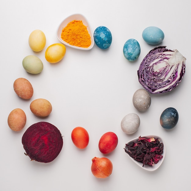 Natural dye for easter eggs - red cabbage, beetroot, carcade, turmeric and onion skin on light background