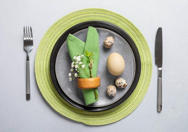 Photo natural easter table gray plates green napkins organic eggs cutlery spring twig gypsophila