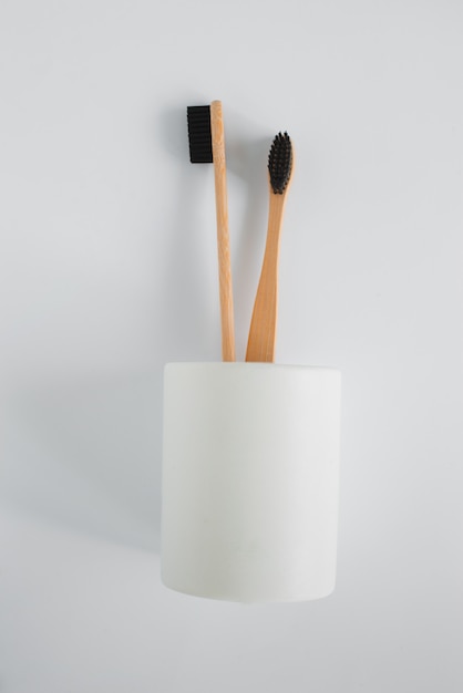 Natural eco bamboo toothbrush in stand on white background top view