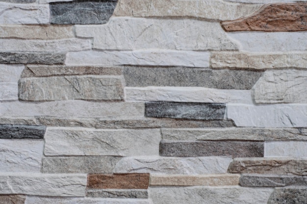 自然なファサードの石の装飾珪岩の背景のテクスチャ。現代の花崗岩の石の壁