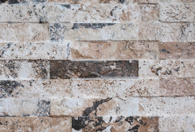 Facciata naturale decorazione in pietra quarzite texture di sfondo. moderno muro di pietra di granito