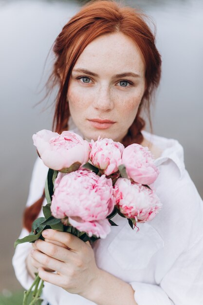 Natural face freckles casual female portrait lifestyle beauty girl with pigtails and flowers