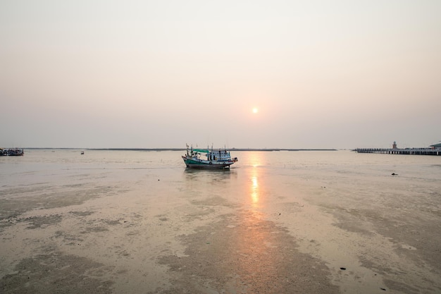 Natural fishing boat on the lane at low tide background beautiful