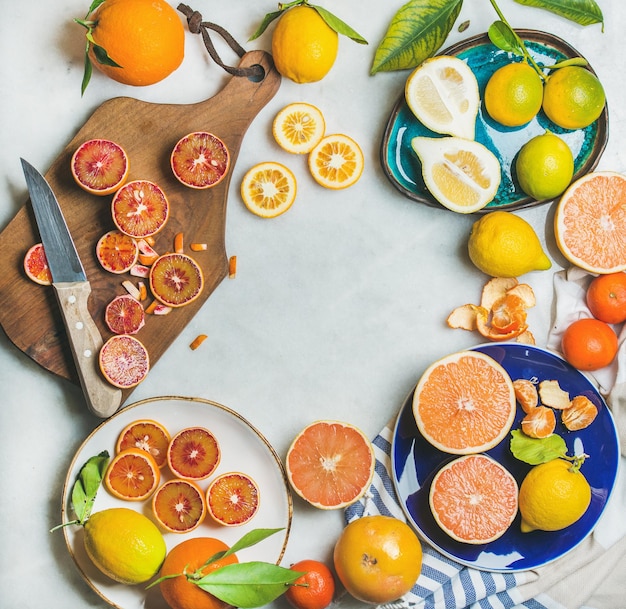 Natural fresh citrus fruits over grey marble table background