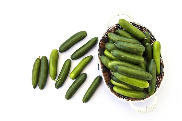 Natural garden cucumbers lined up on a white background