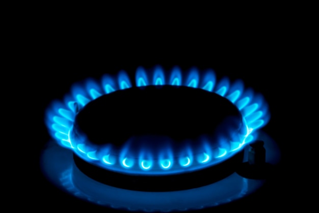 Natural gas burning a blue flames on black background