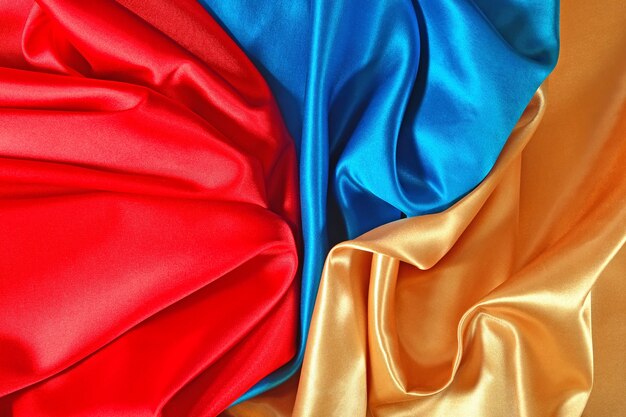 Natural golden, blue and red satin fabric texture