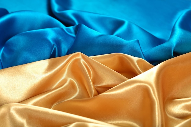 Natural golden and blue satin fabric as background texture