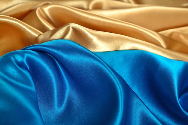 Natural golden and blue satin fabric as background texture