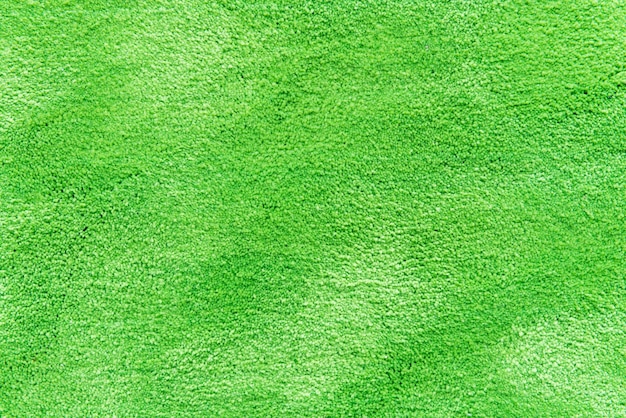 Natural grass texture patterned background in golf course turf from top view: Abstract background of authentic grassy lawn environmental textured pattern backdrop in bright yellow green color tone 