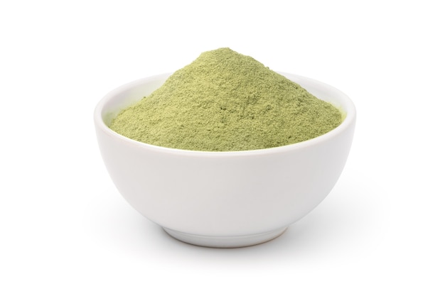 Natural green herb powder in white bowl