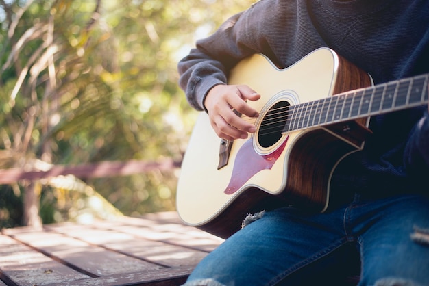 Natural guitarist People playing acoustic guitar in the garden Closeup