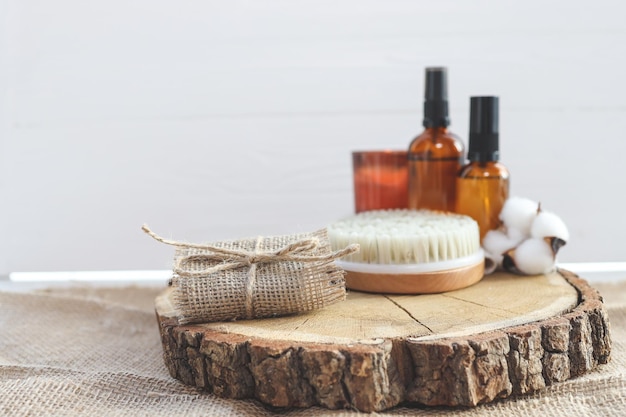 Natural handmade soap and massage brush with oils on a wooden background SPA relax concept