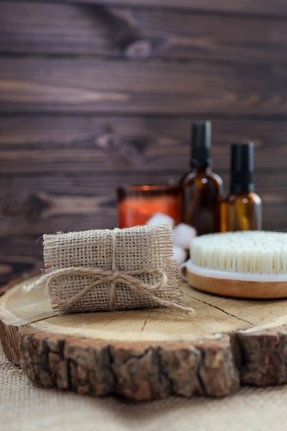 Natural handmade soap and massage brush with oils on a wooden background SPA relax concept